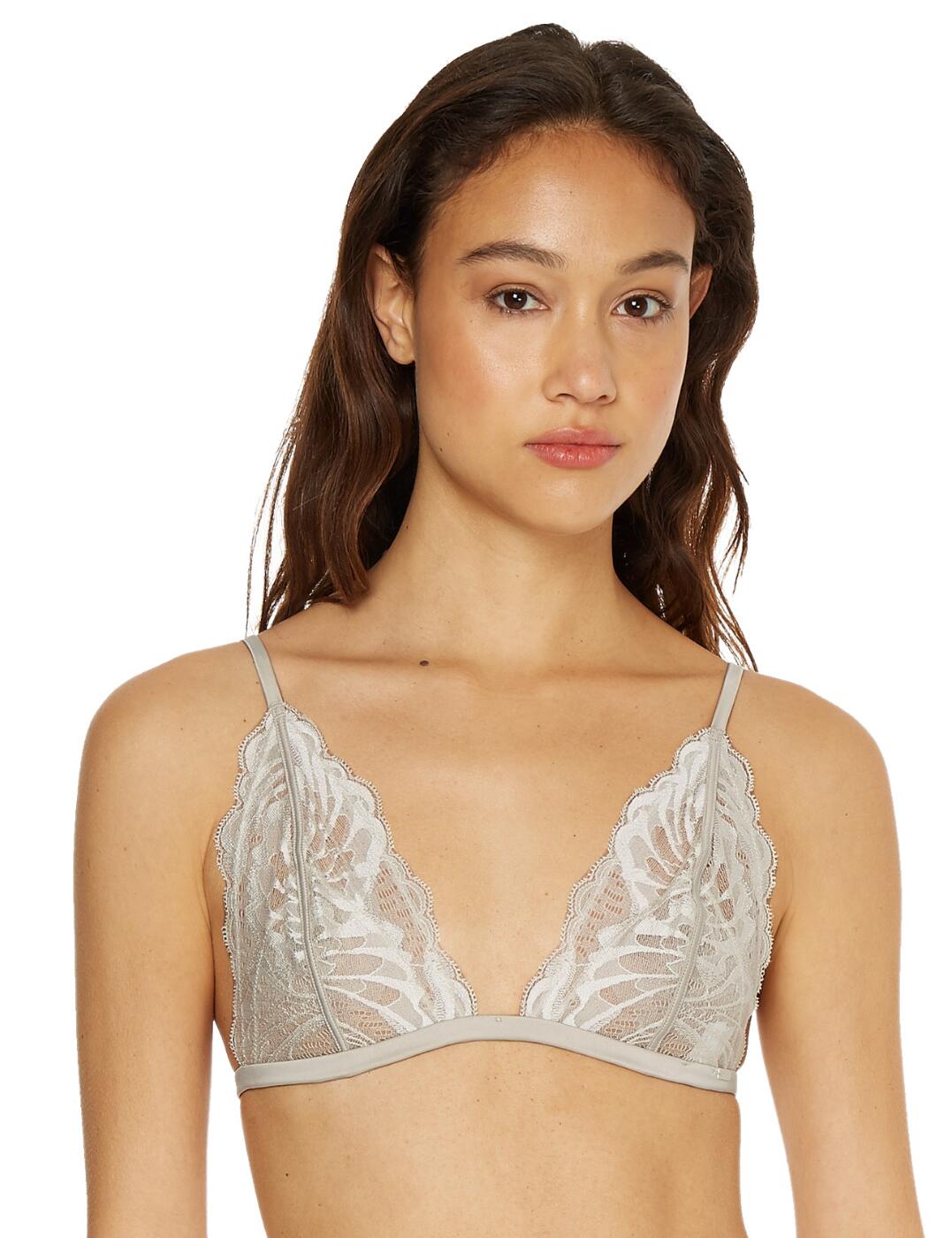 The CK Black Bridal unlined triangle bra by Calvin Klein is a lingerie essential. The glamourous blend of embroidered mesh and satin creates an effortlessly feminine look. Soft unlined cups contour to your curves for a comfortable and natural feel. Plunging cups allow this bra to be easily concealed under even low cut tops. The straps and band are crafted from luxurious satin. Adjustable shoulder straps allow you to find the most comfortable fit. The band features an adjustable slider and fastens with a G-Hook.  Comfortable soft cups Satin band and shoulder straps Partially adjustable shoulder straps and band Scalloped lace edges provide the most complimentary fit Country of origin: China Composition: 81% Nylon &pipe; 12% Elastane Listed in UK sizes  54322-97050 000QF6807E Bralette