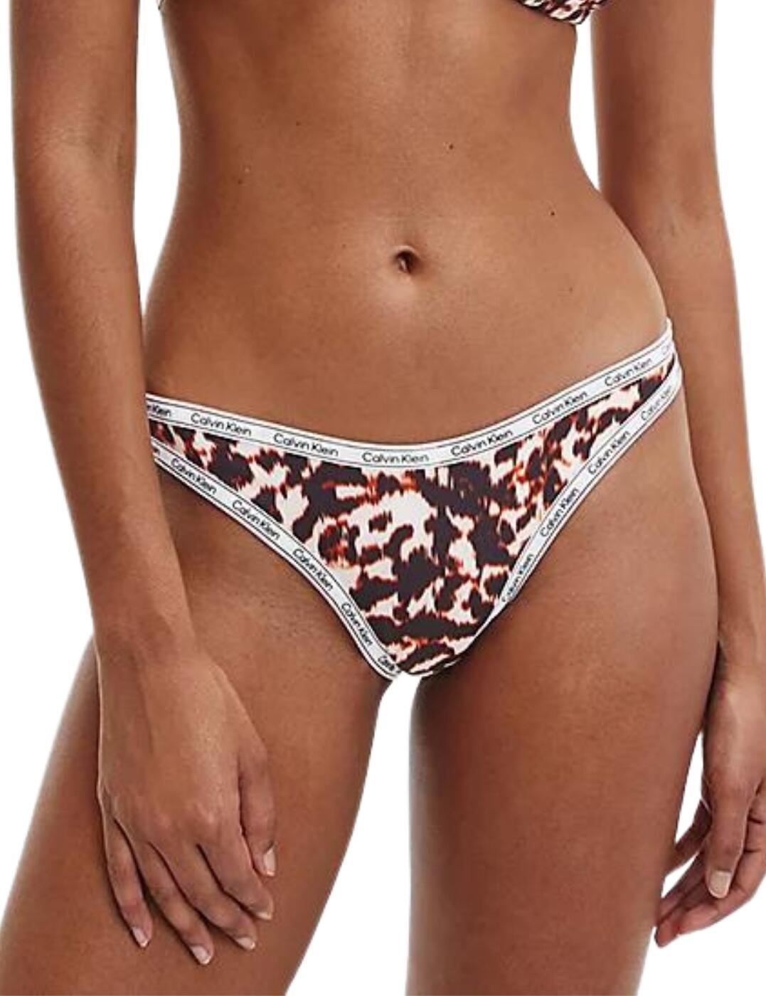 With elevated and refined classics, Calvin Klein's Logo Tape collection has it all. This cheeky bikini brief is as sensual as it is edgy with its bold wild print and its simple signature Calvin Klein logo trim framing your curves. An edgy update of the traditional bikini brief, this piece features a high cut leg detail for an incredibly flattering fit coupled with an extremely flirty Brazilian rear coverage. Fully lined, so you can feel secure and confident day through the night! Feel chic and seductive poolside in this gorgeous cheeky bikini brief.  Effortlessly chic Signature Calvin Klein logo elastic trim High leg cut Cheeky rear coverage Fully lined Country of origin: Sri Lanka Composition: 79% Recycled Polyester&pipe; 21% Elastane Listed in UK sizes  54997-98067-1279785 KW0KW01855  Bikini Briefs