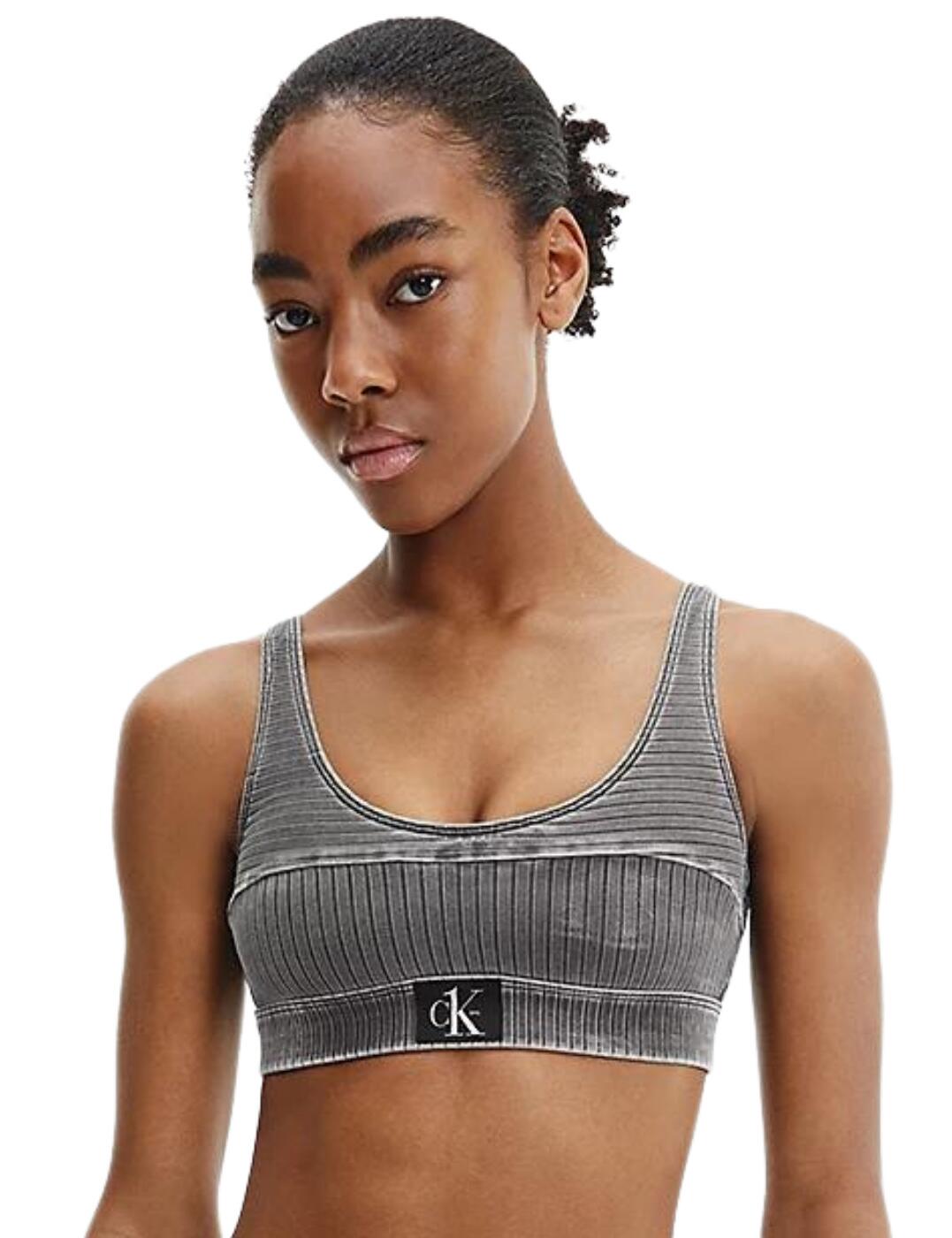 Elevating your everyday essentials to iconic status since 1968, the Calvin Klein CK Authentic collection holds nothing back. This bralette bikini top is heavily inspired by the iconic Calvin Klein jeans with a washed denim flair to them. Crafted with a soft ribbed-knit material, this piece is supremely comfortable without compromising on style, with the classic Calvin Klein badge logo front and centre. Perfect for those wanting to achieve a more sporty rock look, the scoop neckline and back have a very fashion-forward athleisure aesthetic that is too cool to miss. Features soft moulded cups that allow for shaping of the bust, and a comfortable elasticated underband offering security all day long. Would look gorgeous with the matching bikini briefs from the CK Authentic range.  Soft ribbed-knit texture Scoop back and neckline Soft moulded cups Removable padding Elasticated underband Simple pull-on design Calvin Klein badge at the mid-front Made from 91% sustainable fabric Country of origin: Sri Lanka Composition: 91% Recycled Polyamide &pipe; 9% Elastane Listed in UK sizes  55019-98091 KW0KW01753 Bralette Bikini Top