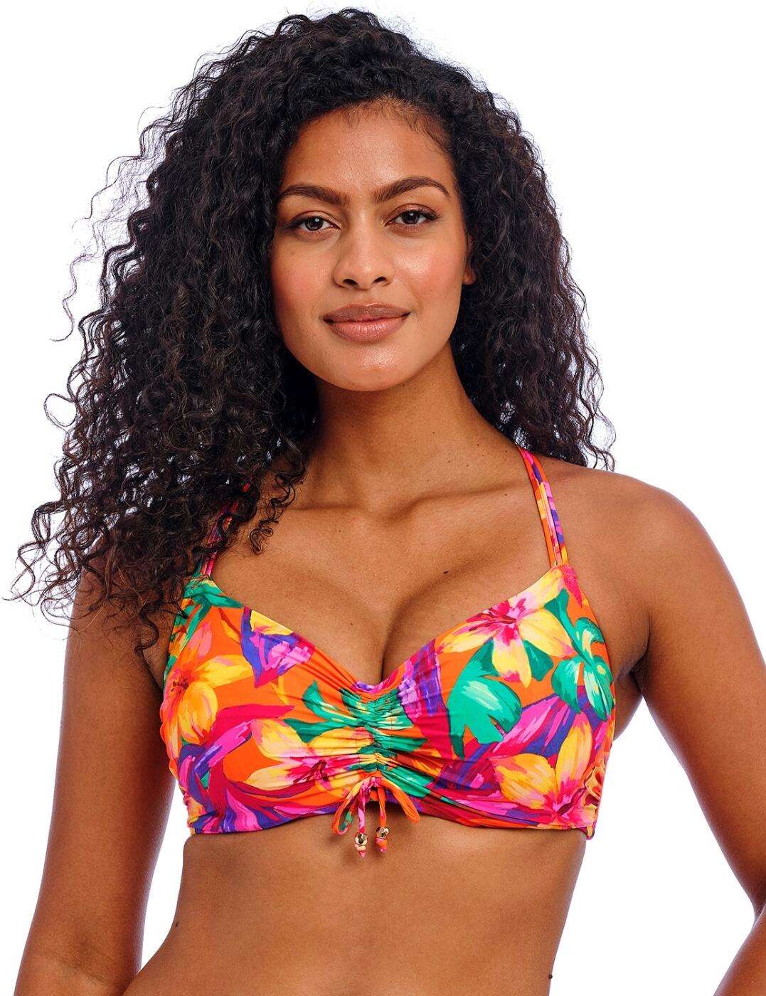 Hit the beach with confidence this season thanks to the Sun Haze bralette bikini top by Freya. Designed for those searching for a tropical twist on a classic style, this bikini top offers a vibrant print to transport you to swimwear paradise. Comfort isn't compromised with non-padded, lined cups providing natural support and a concealed underwire ensuring all-day security, whether you're catching rays by the pool or exploring the beach. At the centre front of the top, the ruching tie allows customisable bust coverage and adds a gathered fabric effect so your look is always personalised and flattering. Adjustable, multiway shoulder straps and a secure plastic clasp closure work with concealed stitching to complete this holiday essential, which can be paired with matching Sun Haze swimwear for a show-stopping poolside ensemble.