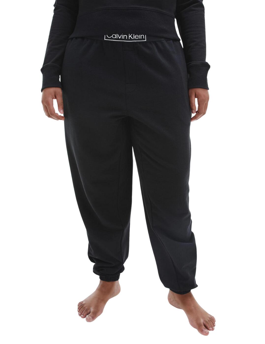 The CK Reimagine Heritage collection is Calvin Klein's reinvention of the classics, combined with a more sustainable mindset. This plus size lounge jogger is fashion-forward without compromising on comfort. A complete staple, this piece is crafted from an incredibly comfortable soft cotton stretch jersey that is a total dream to wear. Features side seam pockets and a cut to a tapered leg, with the bottoms cuffed for a cute but comfortable look. Flaunts the classic Calvin Klein logo as it sits on the waistband of these gorgeous plus size lounge joggers. So comfortable and soft, perfect for a relaxing Netflix and pamper day.  Cute and comfortable! Crafted from cotton stretch jersey Made from recycled fibres Tapered, cuffed leg Side pockets Signature Calvin Klein logo on waistband Country of origin: Sri Lanka Composition: 58% Cotton &pipe; 39% Recycled Polyester &pipe; 3% Elastane Listed in UK sizes  54969-98022-1280555 000QS6833E Plus Size Lounge Jogger